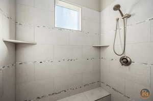 Master Bathroom featuring a tile shower