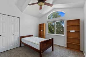 Bedroom #3 upstairs, with carpet, vaulted ceiling, ceiling fan, and a closet