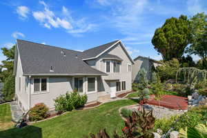 Rear view of house with a yard