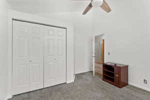 bedroom  #3 upstairs. featuring carpet flooring, ceiling fan, a closet, and vaulted ceiling