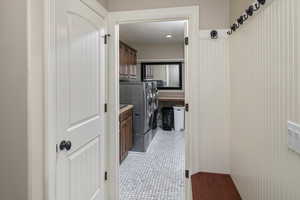 Interior space featuring a textured ceiling, separate washer and dryer, and tile patterned floors