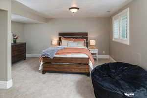 Master bedroom featuring a textured ceiling and carpet flooring