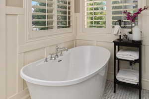 Master bathroom featuring a tub to relax in