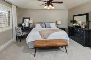 Master bedroom featuring ceiling fan and a tray ceiling