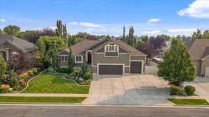 Craftsman-style house with a front lawn and a garage