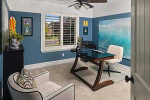 Home office with ceiling fan, ornamental molding, and carpet floors