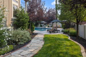 View of yard featuring a fenced in pool and a patio area