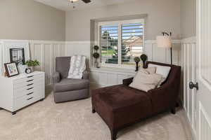 Living area featuring ceiling fan and light carpet