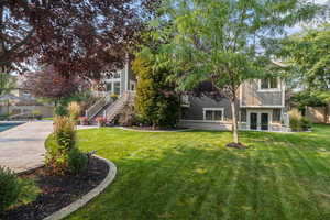 View of yard with french doors and a patio