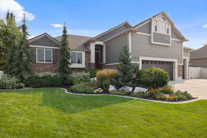 Craftsman-style house with a garage and a front lawn