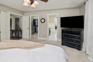 Master bedroom with ensuite bath, a spacious closet, ceiling fan, and a closet