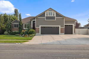 Craftsman-style house featuring a garage and a front yard