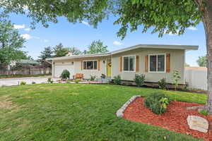 View of front of home featuring a garage and a front lawn