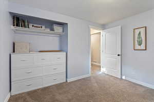 Unfurnished bedroom with light carpet