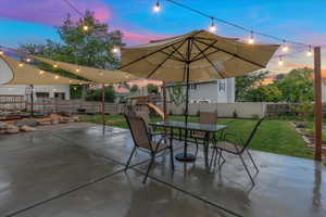 Patio terrace at dusk with a lawn