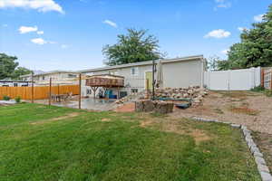 Back of house with a yard, a patio, and a deck