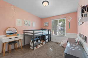 Carpeted bedroom featuring lofted ceiling