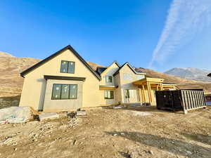 Rear view of property featuring a mountain view