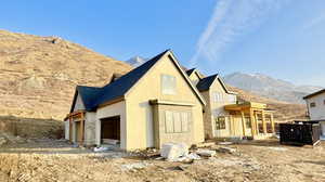 Rear view of property featuring a mountain view and a garage