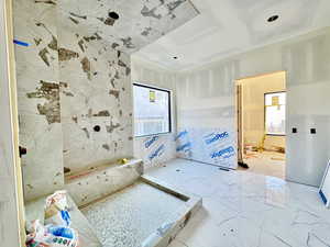 Bathroom featuring tile walls