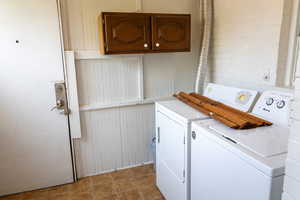 Laundry area with cabinets and washer and dryer