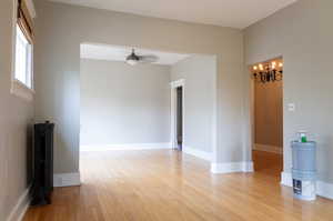 Spare room with ceiling fan and light hardwood / wood-style floors