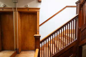 Stairs featuring wood-type flooring