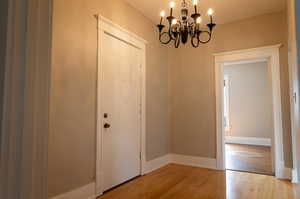 Interior space with light wood-type flooring and a chandelier