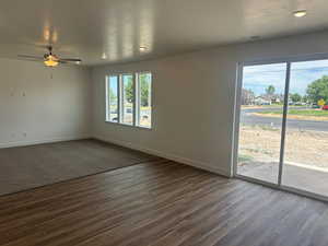 Spare room featuring ceiling fan and dark hardwood / wood-style floors