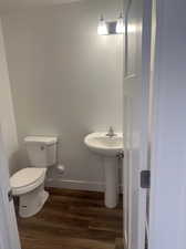 Bathroom featuring wood-type flooring and toilet