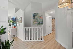 Hall with light hardwood / wood-style floors