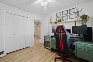 Office space featuring ceiling fan and light hardwood / wood-style floors