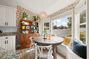 Dining room featuring light wood-type flooring and lofted ceiling