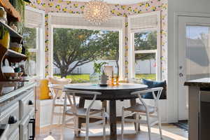 Dining area featuring light hardwood / wood-style flooring, a chandelier, and a healthy amount of sunlight