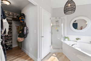 Bathroom with wood-type flooring and plus walk in shower