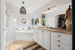 Bathroom featuring vanity, separate shower and tub, and hardwood / wood-style floors