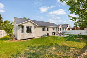 Rear view of property featuring a yard