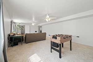 Playroom with light colored carpet and ceiling fan