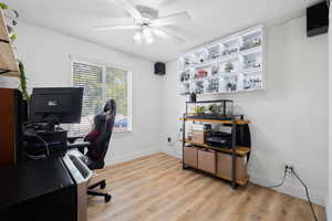 Office space with ceiling fan and light wood-type flooring