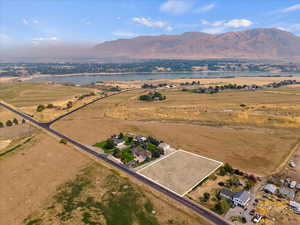 Drone / aerial view with a water and mountain view and a rural view