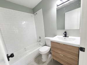 Full bathroom with tiled shower / bath combo and designer fixtures and vanity