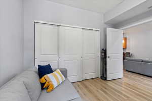 Bedroom with light hardwood / wood-style flooring, French doors