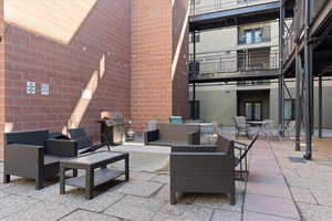 View of patio / terrace featuring area for grilling, an outdoor hangout area, and a balcony