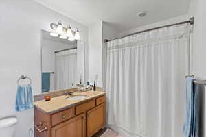 Hall Bathroom featuring vanity, toilet, and walk in shower