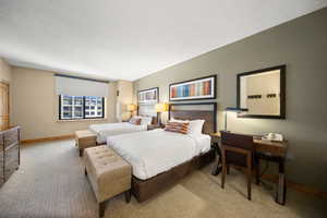 Carpeted bedroom with a textured ceiling