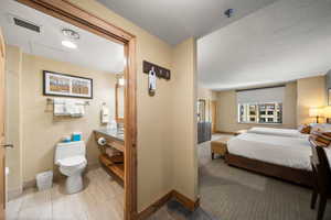 Bedroom featuring light colored carpet