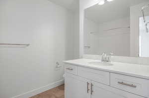 Bathroom with vanity, toilet, tile patterned floors, and walk in shower