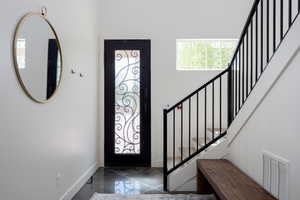 Entryway featuring a towering ceiling