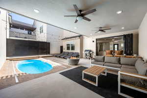 View of swimming pool featuring ceiling fan