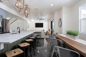 Dining room featuring ceiling fan and sink